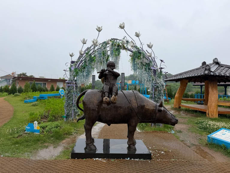 Buffalo and little boy statue